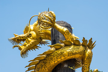 Fototapeta na wymiar Dragon gold is made from scrap steel on blue sky background.