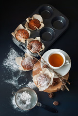 Tea and Muffins with banana, sprinkle powdered sugar