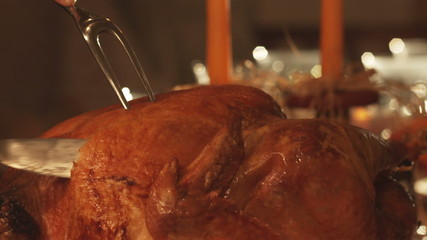 Thanksgiving day turkey being carved, tradional holiday.