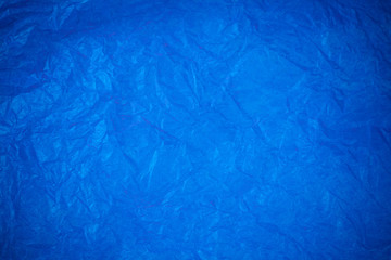 Obraz premium Blue crumpled paper surface background.