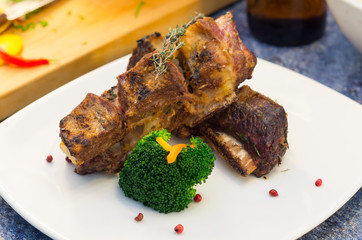 Delicious rib steak and vegetables placed on white plate, elegant presentation