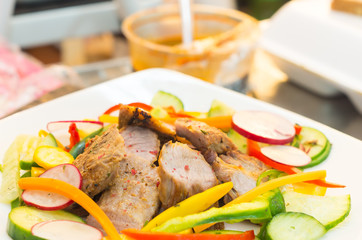 Delicious flank steak cuts cooked to perfection, mixed with reddish, zucchini and capsicum, elegant presentation
