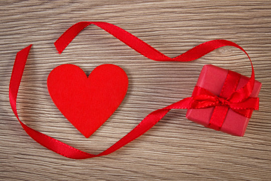 Wrapped gift with ribbon and heart for Valentines Day, copy space for text
