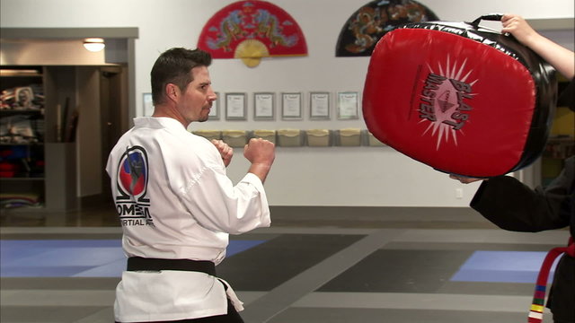 Close up of a bag being kicked at a karate studio.