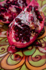 pomegranate slices on a plate with Oriental pattern