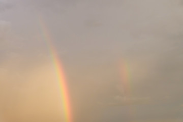 colorful rainbow on rain cloud sunset sky