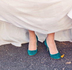 Bride  show off her turquoise shoes at wedding