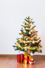 blur background, light celebration on christmas tree with gift box in living room