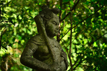 Fototapeta na wymiar 仏像　京都　仁和寺 制多迦童子, statue of a Buddhism guardian of in woods, ninna-ji temple Kyoto Japan.