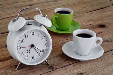 Two cups of espresso with an alarm clock