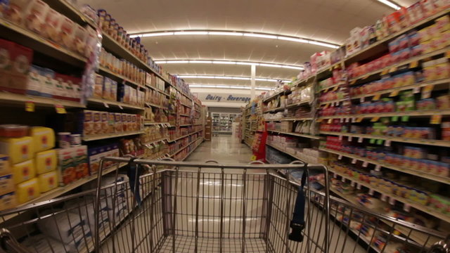 Grocery shopping gart passing through aisle, wide angle.