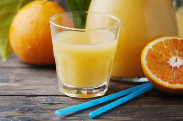 Healthy fresh orange juice on the woodent table