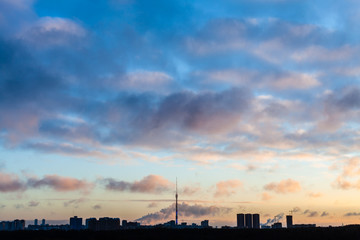 dark blue sky over city in cold winter sunrise