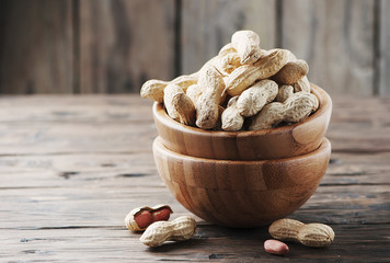 Paenut in the bowl in the wooden table