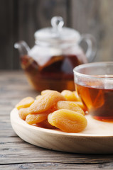 Swwet dried apricots with cup of black tea