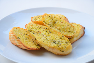 Garlic and herb bread slices. garlic bread against white background