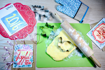 Homemade cookies,cookie cutter,rolling pin,card on the wooden ba
