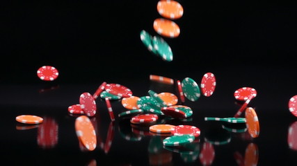 Falling poker chips slow motion - black background. - Powered by Adobe