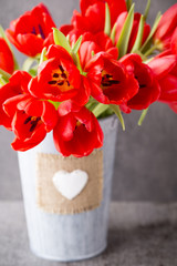 Red tulips on a wooden background.
