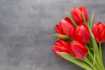 Red tulips on a wooden background.