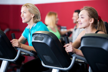 Fototapeta premium People training on exercise bikes together