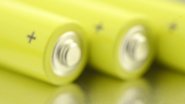 AA batteries close-up. Slow sliding motion. Symbol of energy, power and recycling.