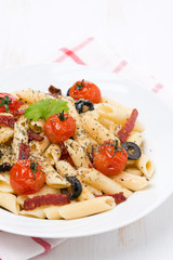 pasta with sausage, tomatoes and olives, vertical