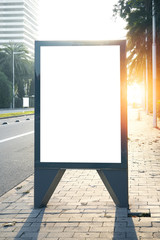 Blank lightbox on the city streets. Vertical. Sunlights effects