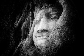 Peaceful and tranquil face of Buddha carved on ancient stone