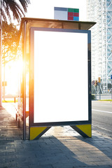 Blank lightbox on the bus stop. Sunlights effects. Vertical