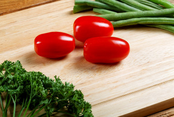 Small tomatoes and salad leaves close up