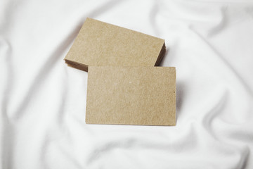 Fototapeta premium Set of blanks craft business cards on white tshirt. Horizontal