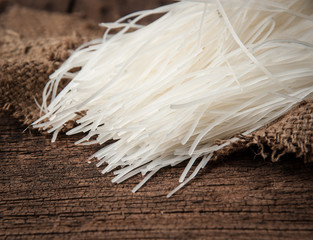 Rice noodles on wood background