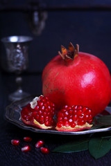 large red pomegranate on a black background