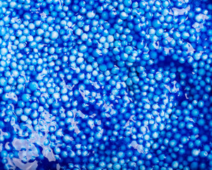 Abstract Colorful background - textured dark blue wet Plasticine