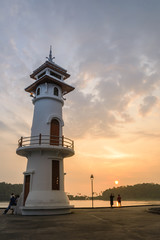 Sunset on lighthouse with tourist at the sea pier on Ko Chang is