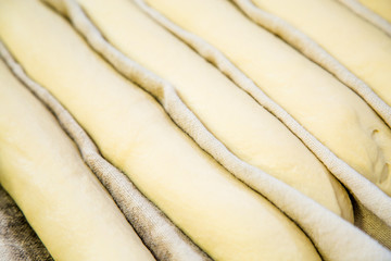 A plain baguette ready to bake on baking tray