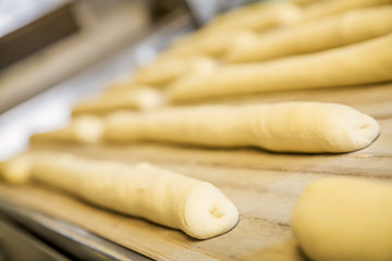 A plain baguette ready to bake on baking tray