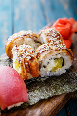 Sushi set on a wooden tray.