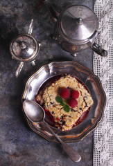 raspberry crumble in a metal plate with a fork