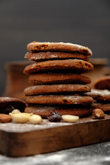 Gingerbread cookies dusted with icing sugar on a wooden table