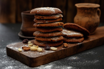 Gingerbread cookies dusted with icing sugar on a wooden table