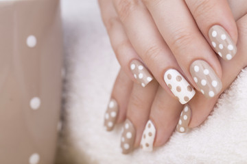 Beauty treatment photo of nice manicured woman fingernails. Very nice feminine nail art with nice nude and white nail polish.