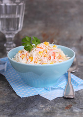 salad of corn crab sticks and cabbage in a blue plate