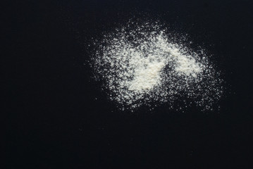 white flour on black background - free space for text