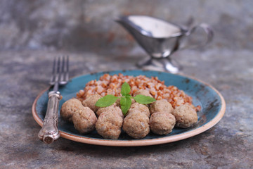 pork meatballs in a vintage blue plate on a gray background