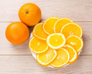 sliced oranges isolated on wooden table background