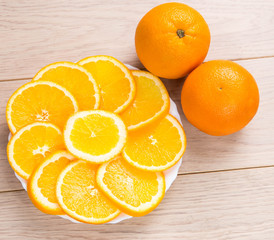 sliced oranges isolated on wooden table background