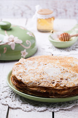 Stack of pancakes with honey and butter.Carnival,a traditional Russian holiday.selective focus.