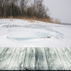 Snowy winter in Russia. View from dark wooden gangway, table or